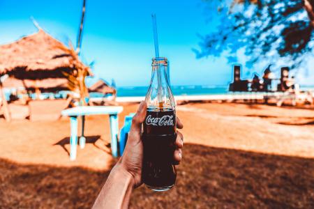 Person Holding Coca-cola Glass Bottle