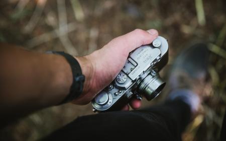 Person Holding Grey Point-and-shoot Camera