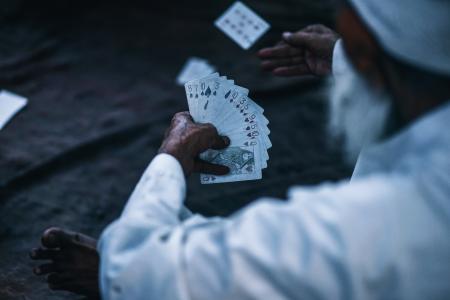 Person Holding Playing Cards