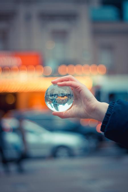 Person Holding Round Glass Ball Macro Shot