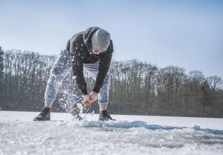 Person Holding Shovel on Snow Field