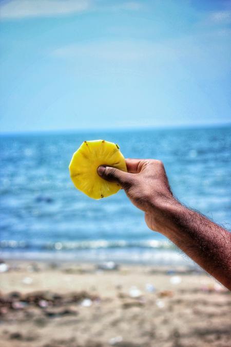 Person Holding Sliced Pineapple