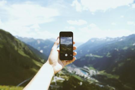 Person Holding Space Gray Iphone 5s Taking Picture of Mountains