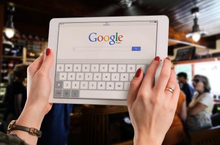 Person Holding White Ipad