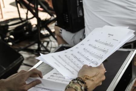 Person Holding White Musical Note Sheets