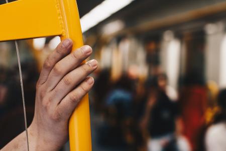 Person Holding Yellow Metal Chair