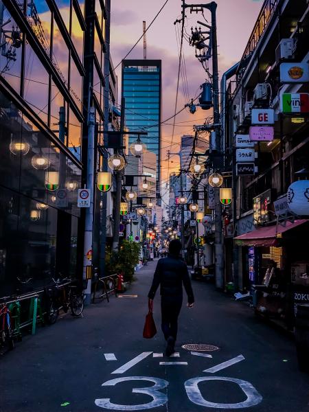 Person in Black Jacket Carrying Red Handbag