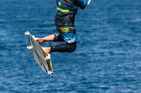 Person in Blue and Black Board Shorts on White Wake Board