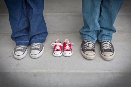 Person in Blue Denim Pants Wearing Gray and White Low Tops