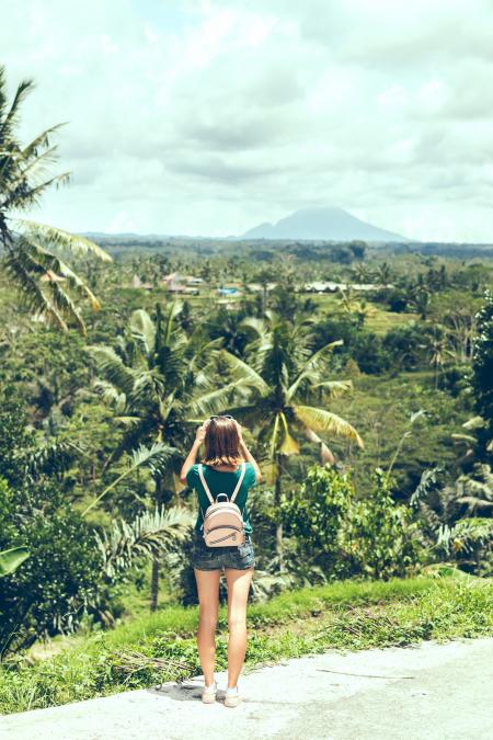 Person in Green Shirt Taking Photos of Nature