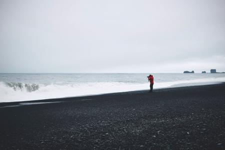 Person in Red Top Standing Near Body of Water