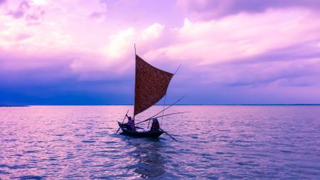 Person in Sailboat on Body of Water during Golden Hour