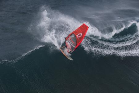 Person in Surfboard in the Wave during Daytime