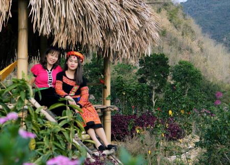 Person in Traditional Dress Sitting on Hut