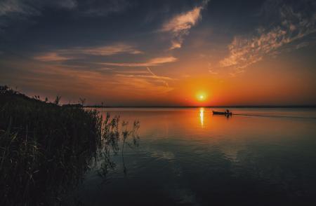 Person on a Boat Traveling during Sun Set