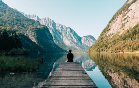 Person on a Bridge Near a Lake