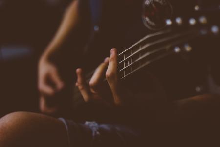 Person Playing Guitar