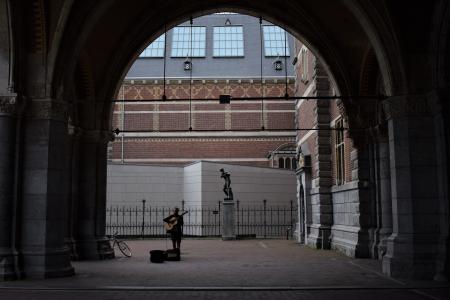 Person Playing Guitar on Street