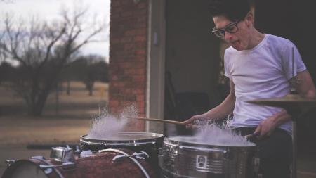 Person Playing on Drums during Daytime