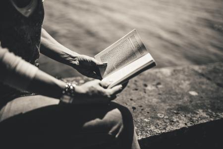 Person Reading a Book While Sitting during Day Time