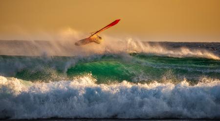 Person Ridding Wind Boat Above Ocean Wave