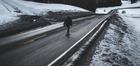 Person Running on Asphalt Road