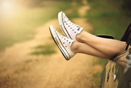 Person Showing Its Feet Wearing White Sneakers