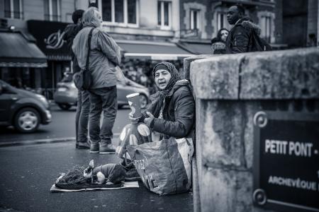 Person Sitting Behind Wall Grayscale Photo