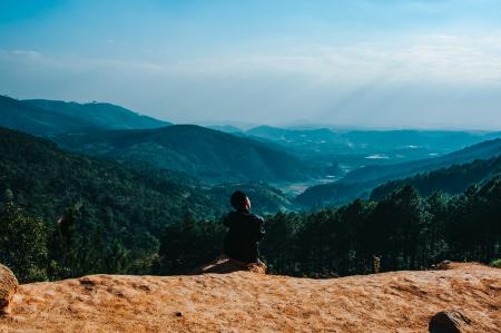 Person Sitting By The Cliff