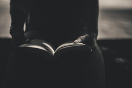 Person Sitting While Open the Book