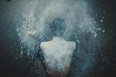 Person Splashing Powder on His Back