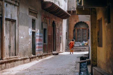 Person Standing Between Two Buildings