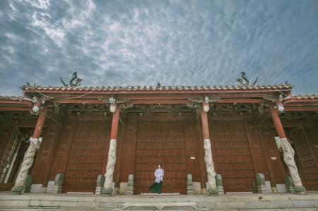 Person Standing Near Red Gate