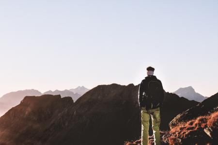 Person Standing on Top of the Mountain