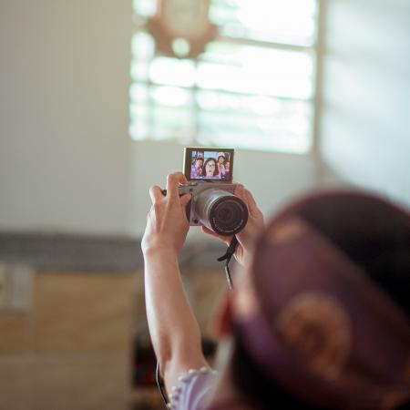 Person Taking Groupie Using Gray Bridge Camera