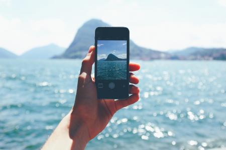 Person Taking Photo of Mountain