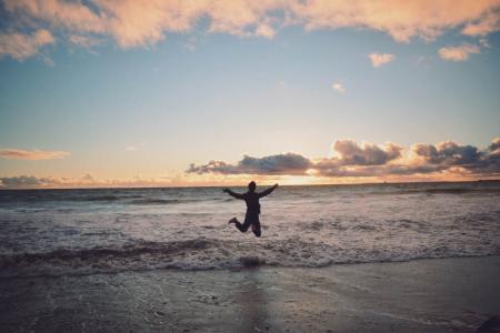 Person Taking Picture in Seashore during Sunset