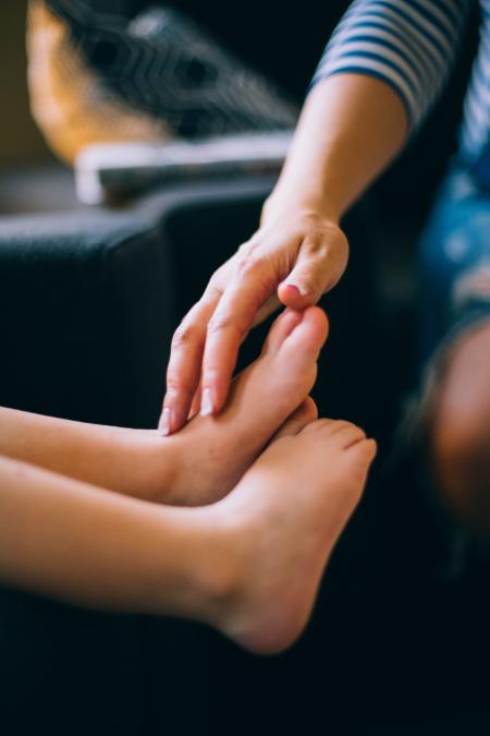 Person Touching Child's Feet