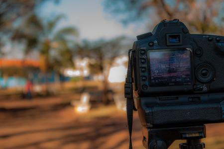 Person Using Black Dslr Camera