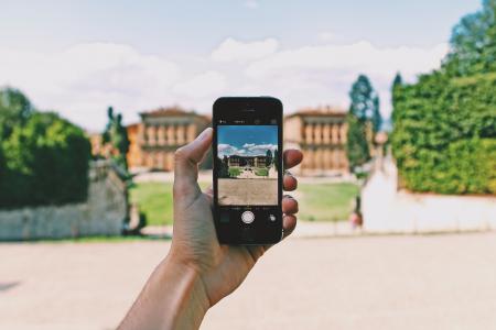 Person Using Space Gray Iphone 5s Taking a Picture of Landmark during Day