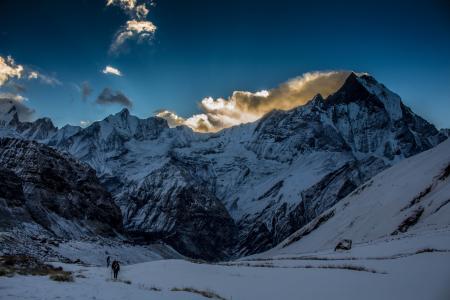 Person Walking in Snow Mountain