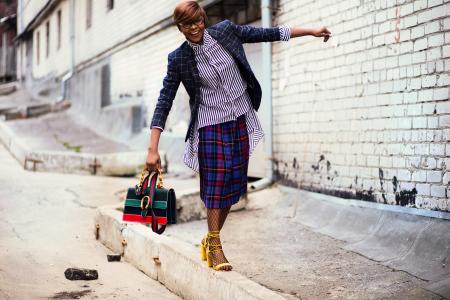 Person Wearing Blue and Black Blazer Holding Bag