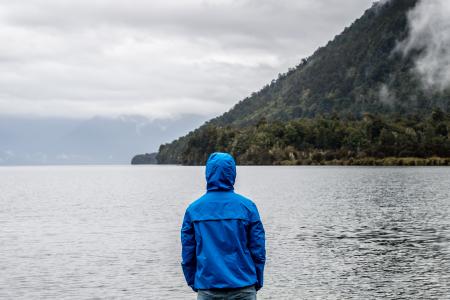 Person Wearing Blue Hoodie Near Body of Water