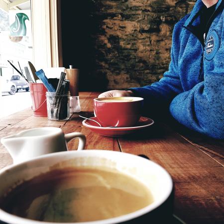 Person Wearing Blue Jacket Holding Red Cup