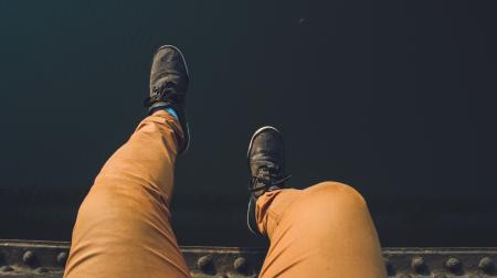 Person Wearing Brown Jeans With Pair of Black Sneakers