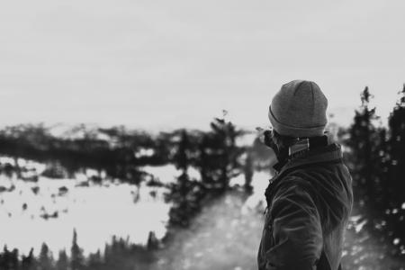 Person Wearing Jacket Pointing the Glacier Mountain
