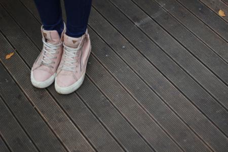 Person Wearing Pink and White High Top Sneakers