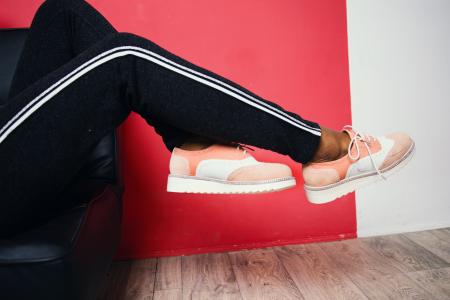 Person Wearing Pink-and-white Low-top Sneakers and Black Track Pants