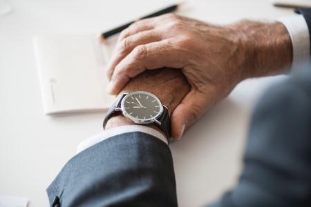 Person Wearing Round Analog Watch With Black Strap