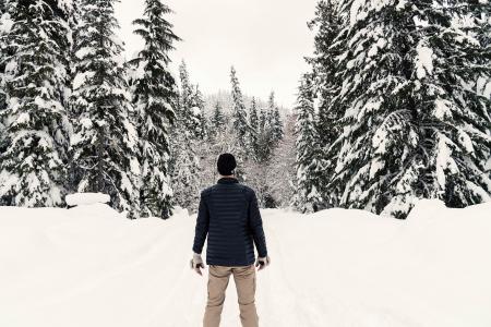 Photo of a Man in the Snowy Forest